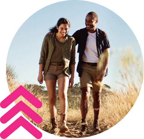 A woman and a man walking on a field