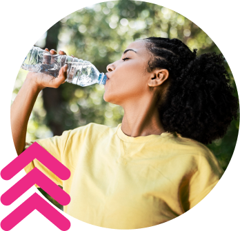 A woman drinking from a bottle